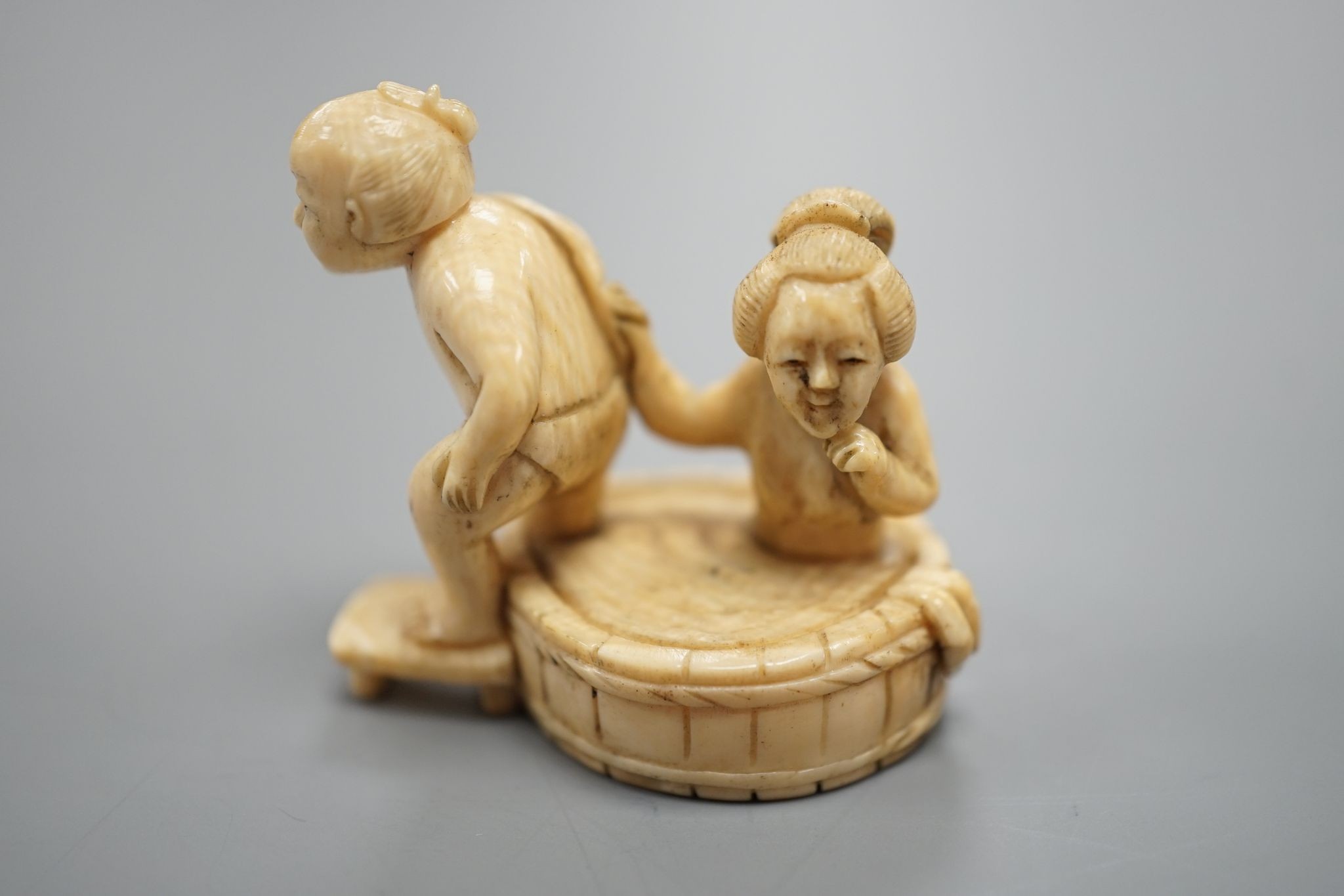 A Japanese ivory Netsuke of a bathing couple, Meiji period, 3.5 cms high.